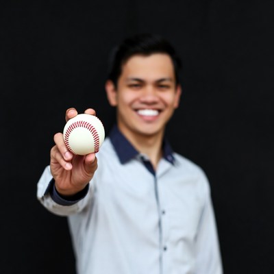 Asian man holding baseball