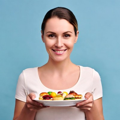 Woman holding plate of appetizers