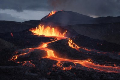 Volcano erupting with glowing lava flows