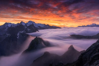 Snowy Mountains in Sunset Clouds