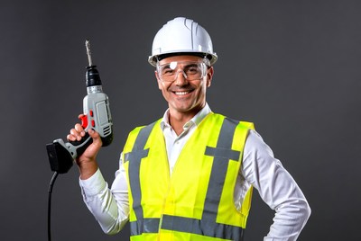 Man holding drill in safety gear