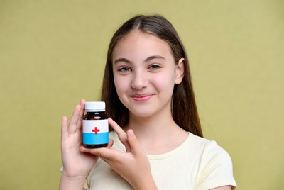 Girl holding medicine bottle