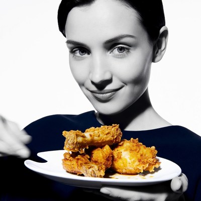 Woman holding fried chicken plate