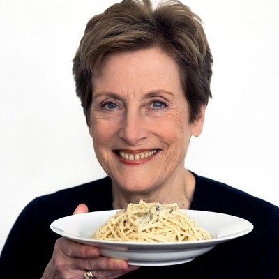 Woman holding spaghetti plate