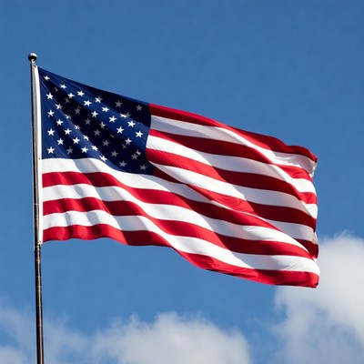 American flag waving against blue sky