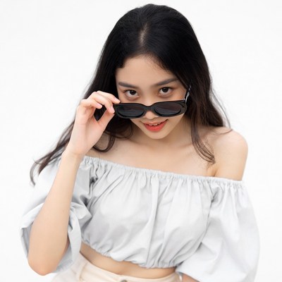 Asian woman peeking over sunglasses