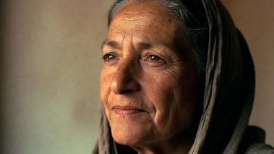 Elderly woman wearing gray headscarf