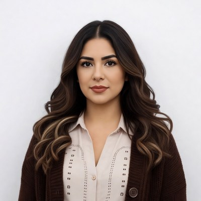 Latina woman in white blouse and brown cardigan