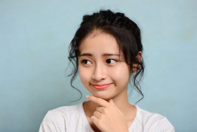 Asian woman thinking with hand on chin