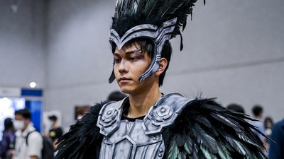 Man in black feathered cosplay armor