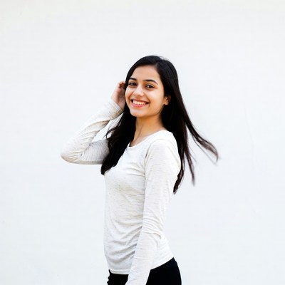 Indian woman smiling with hand on hair