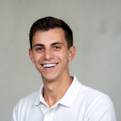 Smiling young man in white polo