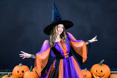Woman in Witch Costume with Pumpkins