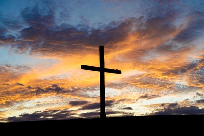 Silhouette cross at sunset
