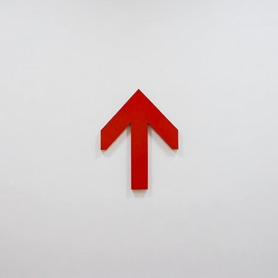 Red upward arrow on white