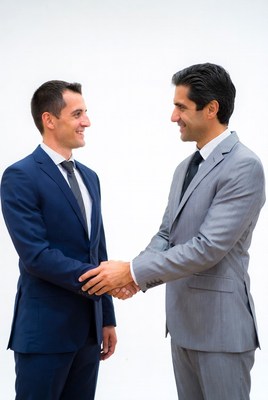 Two men shaking hands in suits