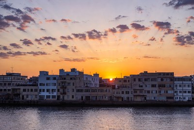 Sunset over waterfront buildings