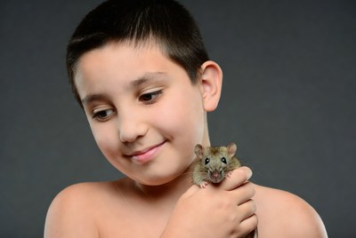 Boy holding cute rat