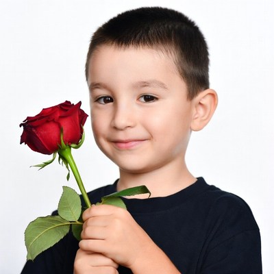 Boy holding red rose