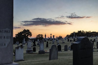Sunset over cemetery tombstones