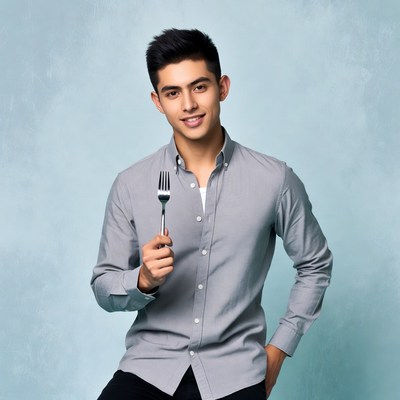 Young Asian man holding fork