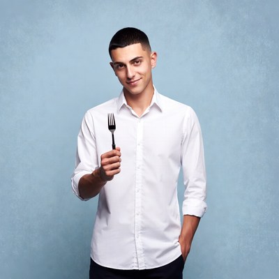 Man holding fork on blue background