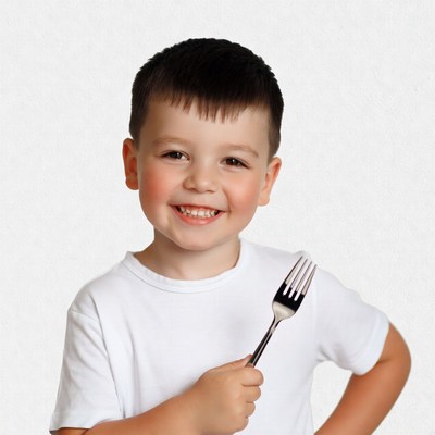 Boy holding fork smiling