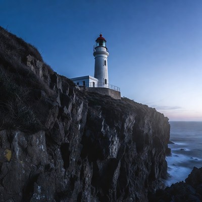 White lighthouse on coastal cliff