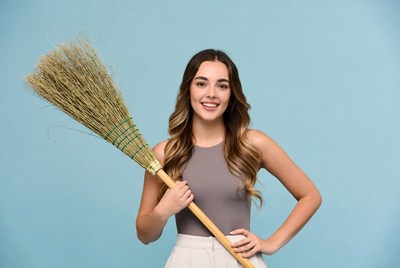 Young woman holding broom