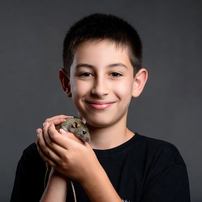 Boy holding pet rat