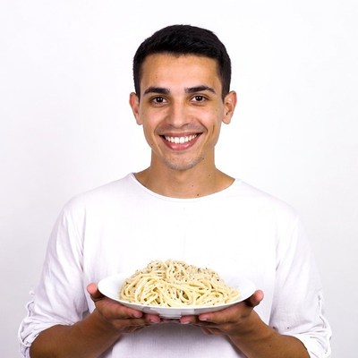 Man holding plate of spaghetti