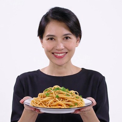 Asian woman holding spaghetti plate