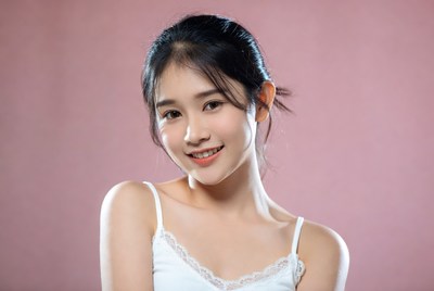 Asian woman smiling in white camisole