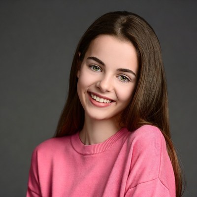 Smiling teenage girl in pink sweater