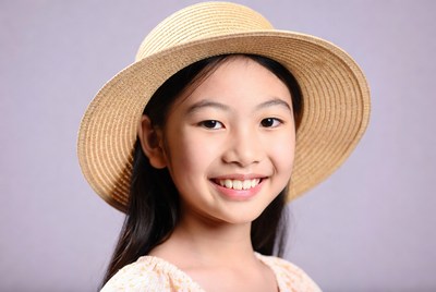 Asian girl smiling in straw hat