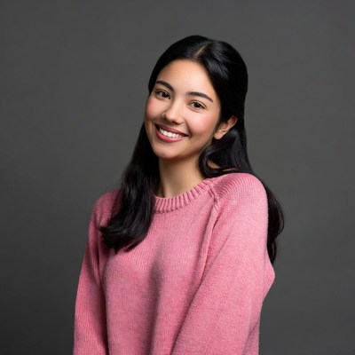 Asian woman smiling in pink sweater