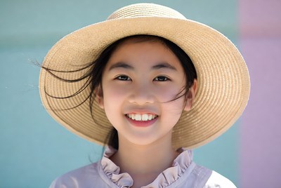 Asian girl smiling in straw hat
