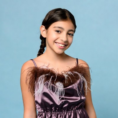 Latina girl in feathered dress smiling