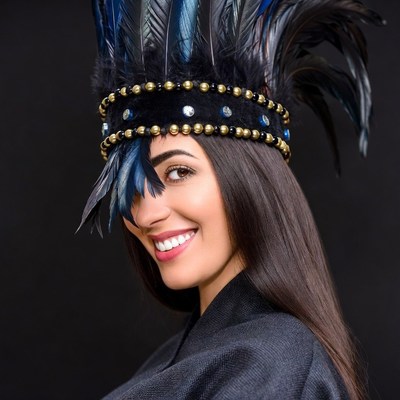 Woman smiling in blue feather headdress