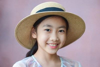 Asian girl smiling in straw hat