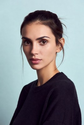 Woman with dark hair on blue background