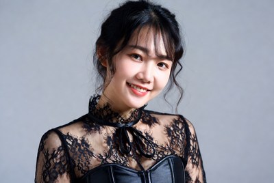 Asian woman in black lace corset top