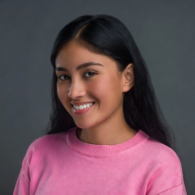 Smiling Asian woman in pink sweater