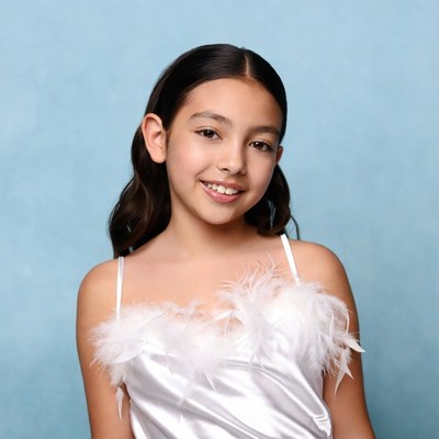Young girl in feathered white dress
