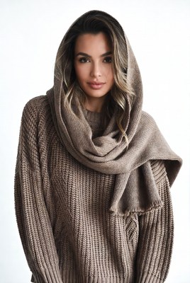 Woman in knitted hoodie and scarf