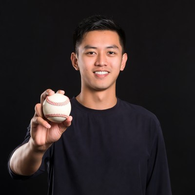 Asian man holding baseball