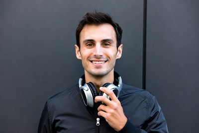 Man holding headphones smiling