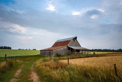 Rustic red barn in green fields