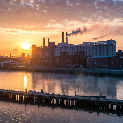 Industrial Factories at Sunset by River