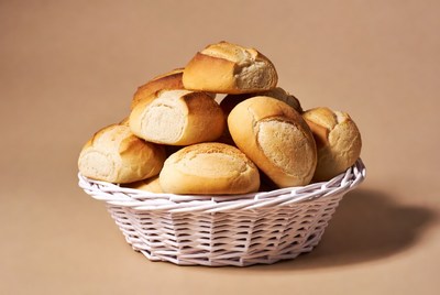 Fresh bread rolls in white basket